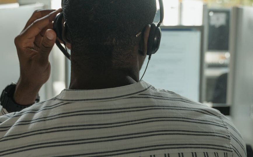 back view of a man in white striped long sleeves working in the office